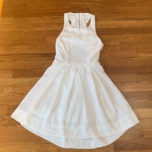 White sleeveless skater style dress with open back